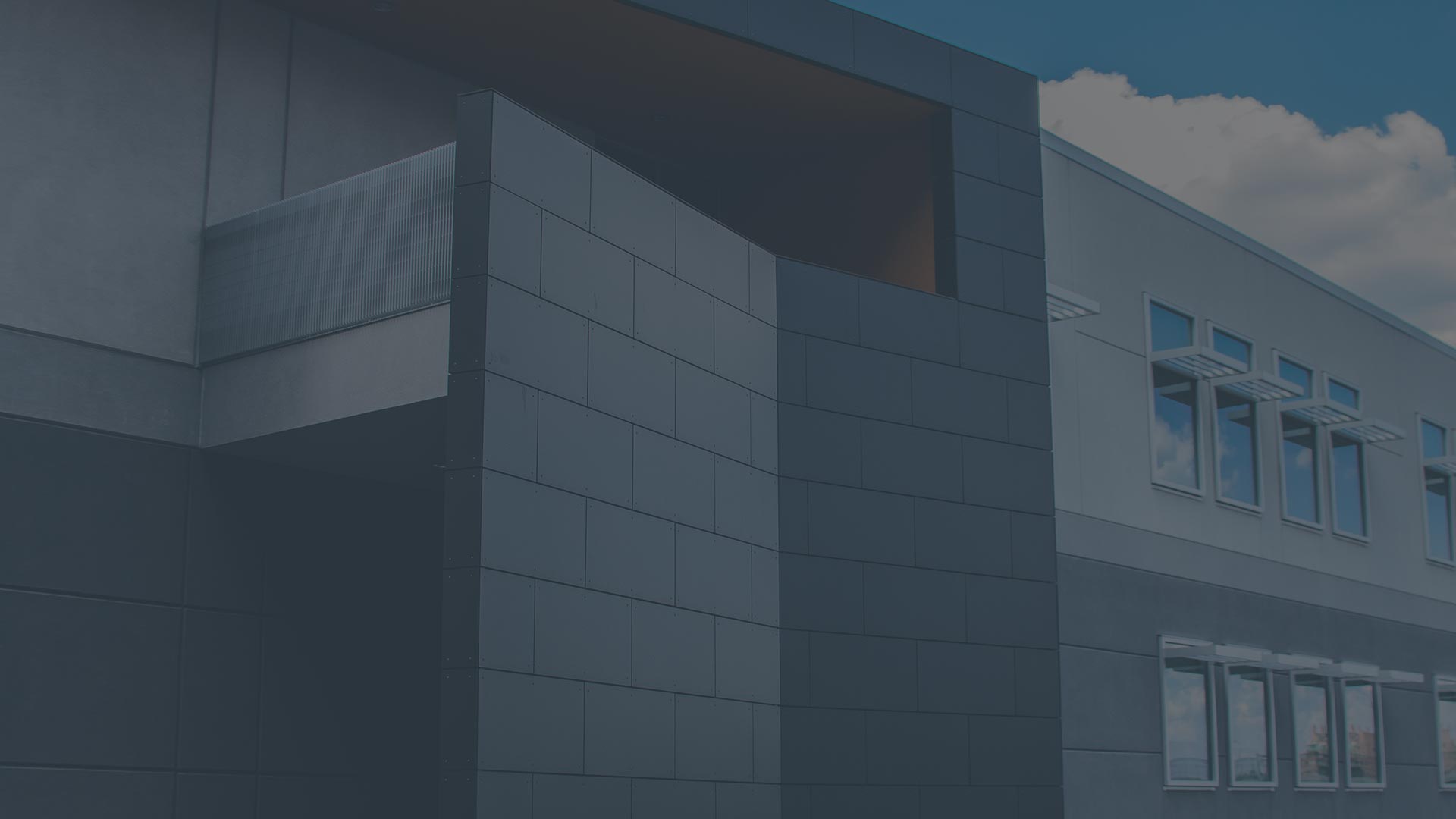 Modern office building facade against a blue sky